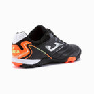 Joma Maxima Adult Turf Soccer Shoes in black with orange and white accents, showcasing superior traction and lightweight design.